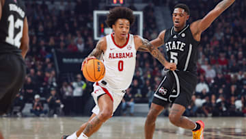Jan 29, 2025; Starkville, Mississippi, USA; Alabama Crimson Tide guard Labaron Philon (0) drives to the basket against Mississippi State Bulldogs guard Shawn Jones Jr. (5) during the first half at Humphrey Coliseum. Mandatory Credit: Wesley Hale-Imagn Images