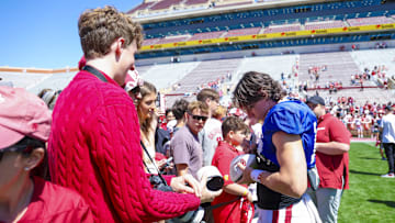 Apr 12, 2025; Norman, OK, USA;  Oklahoma Sooners quarterback John Mateer (10) signs autographs after the Crimson Combine at Gaylord Family-Oklahoma Memorial Stadium. Mandatory Credit: Kevin Jairaj-Imagn Images