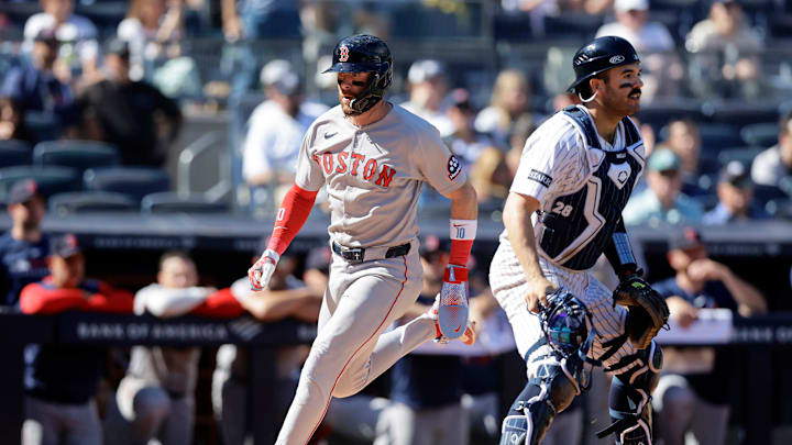 Trevor Story crosses the plate for the Boston Red Sox in a game against the New York Yankees.