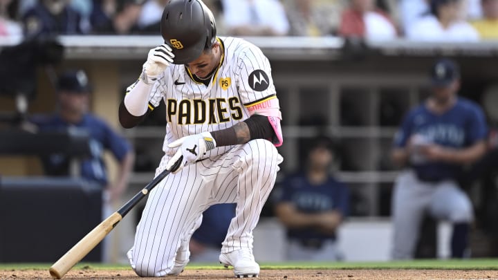 Jul 10, 2024; San Diego, California, USA; San Diego Padres designated hitter Manny Machado (13) reacts after falling while avoiding an inside pitch during the ninth inning against the Seattle Mariners at Petco Park. Mandatory Credit: Orlando Ramirez-USA TODAY Sports