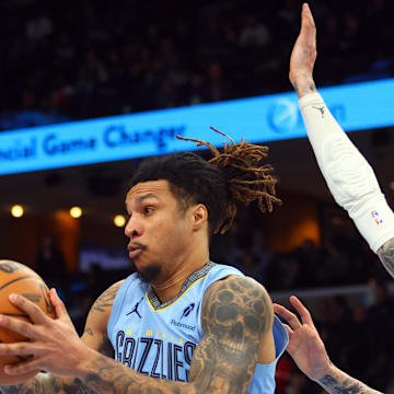 Jan 22, 2025; Memphis, Tennessee, USA;  Memphis Grizzlies forward Brandon Clarke (15) collects a rebound over Charlotte Hornets guard LaMelo Ball (1) during the fourth quarter at FedExForum. Mandatory Credit: Petre Thomas-Imagn Images