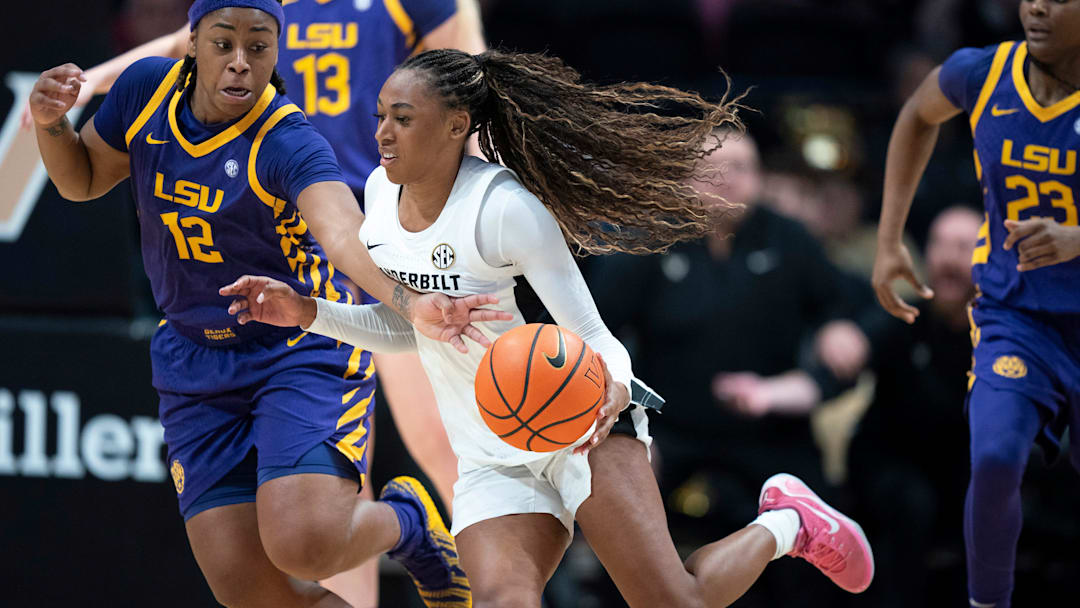 Louisiana State guard Mikaylah Williams (12) fouls a driving Vanderbilt guard Mikayla Blakes (1) during their game at Memorial Gymnasium Sunday, Jan. 4, 2026.