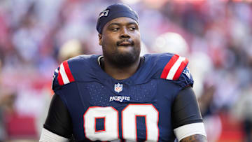 Dec 15, 2024; Glendale, Arizona, USA; New England Patriots defensive tackle Christian Barmore (90) against the Arizona Cardinals at State Farm Stadium. Mandatory Credit: Mark J. Rebilas-Imagn Images