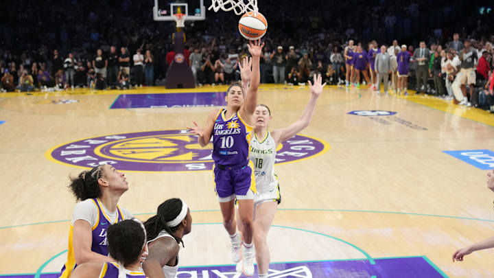 Aug 20, 2025; Los Angeles, California, USA; LA Sparks guard Kelsey Plum (10) scores with no time remaining against Dallas Wings center Luisa Geiselsoder (18) for the game-winning basket at Crypto.com Arena. Mandatory Credit: Kirby Lee-Imagn Images