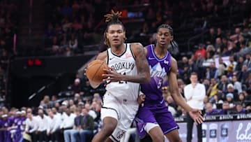 Jan 12, 2025; Salt Lake City, Utah, USA; Brooklyn Nets forward Noah Clowney (21) goes to the basket against Utah Jazz forward Cody Williams (5) during the first quarter at Delta Center. Mandatory Credit: Rob Gray-Imagn Images