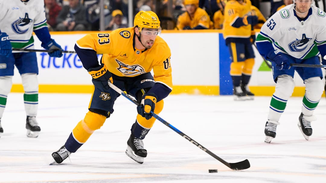 Jan 29, 2025; Nashville, Tennessee, USA;  Nashville Predators defenseman Adam Wilsby (83) skates with the puck against the Vancouver Canucks during the first period at Bridgestone Arena. Mandatory Credit: Steve Roberts-Imagn Images