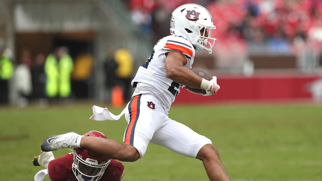 Oct 25, 2025; Fayetteville, Arkansas, USA; Auburn Tigers running back Jeremiah Cobb (23) rushes during the second quarter against the Arkansas Razorbacks at Donald W. Reynolds Razorback Stadium. Mandatory Credit: Nelson Chenault-Imagn Images