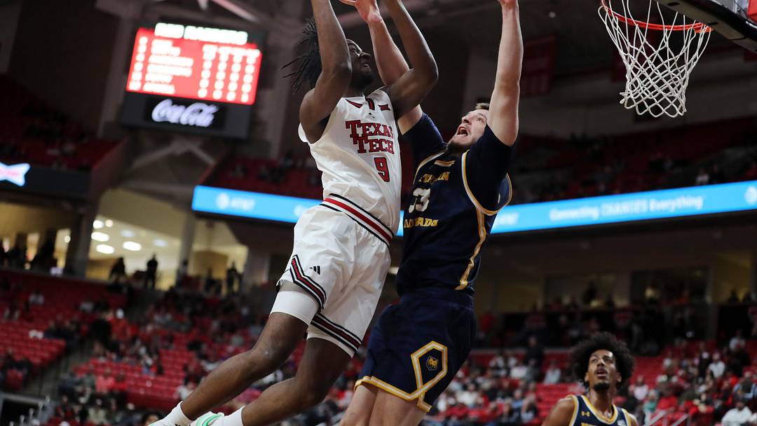 Dec 16, 2025; Lubbock, Texas, USA;  Texas Tech Red Raiders forward Luke Bamgboye (9) goes to the basket against Northern Colorado Bears center Egan Shields (33) in the first half at United Supermarkets Arena. Mandatory Credit: Michael C. Johnson-Imagn Images