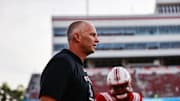 Aug 28, 2025; Raleigh, North Carolina, USA; North Carolina State Wolfpack head coach Dave Doeren looks on during the warmups prior to the game against East Carolina Pirates at Carter-Finley Stadium. Mandatory Credit: Jaylynn Nash-Imagn Images