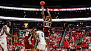 Feb 15, 2025; Raleigh, North Carolina, USA; Boston College Eagles guard Donald Hand Jr. (13) shoots a three pointer past forward Chad Venning (32) and North Carolina State Wolfpack guard Jayden Taylor (8) during the second half of the game at Lenovo Center. Mandatory Credit: Jaylynn Nash-Imagn Images