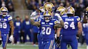 Nov 9, 2024; Winnipeg, Manitoba, CAN;  Winnipeg Blue Bombers running back Brady Oliveira (20) celebrates his run during the first half of the game between the Winnipeg Blue Bombers and the Saskatchewan Roughriders at Princess Auto Stadium. Mandatory Credit: Bruce Fedyck-Imagn Images