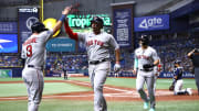 Apr 12, 2023; St. Petersburg, Florida, USA; Boston Red Sox third baseman Rafael Devers (11) is congratulated by first baseman Justin Turner (2) and catcher Reese McGuire (3) after he hit a 3-run home run against the Tampa Bay Rays during the seventh inning at Tropicana Field.
