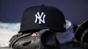 Aug 14, 2023; Atlanta, Georgia, USA; A detailed view of a New York Yankees hat and glove on the bench against the Atlanta Braves in the third inning at Truist Park. Mandatory Credit: Brett Davis-Imagn Images