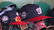 Apr 17, 2025; Pittsburgh, Pennsylvania, USA; Washington Nationals hats and gloves in the dugout against the Pittsburgh Pirates during the sixth inning at PNC Park. Mandatory Credit: Charles LeClaire-Imagn Images