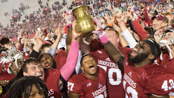 Oct 1, 2016; Bloomington, IN, USA; Indiana Hoosiers offensive lineman Jacob Bailey (70) and linebacker Dameon Willis Jr. (43) and other teammates hoist the brass spittoon in victory after the game against the Michigan State Spartans at Memorial Stadium. Indiana Hoosiers beat the Michigan State Spartans by the score of 24-21. Mandatory Credit: Trevor Ruszkowski-Imagn Images