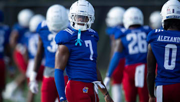Kansas redshirt junior wide receiver Cam Pickett (7) warms up with players during an outdoor practice on July 30, 2025.