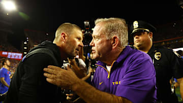 Nov 16, 2024; Gainesville, Florida, USA; LSU Tigers head coach Brian Kelly and Florida Gators head coach Billy Napier greet after the game at Ben Hill Griffin Stadium. Mandatory Credit: Kim Klement Neitzel-Imagn Images