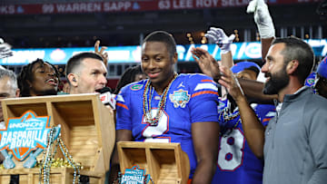 Dec 20, 2024; Tampa, FL, USA; Florida Gators quarterback DJ Lagway (2) is presented the MVP trophy after the win against the Tulane Green Wave at Raymond James Stadium. Mandatory Credit: Kim Klement Neitzel-Imagn Images