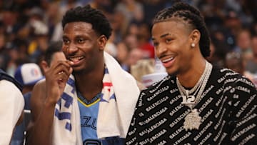 May 11, 2022; Memphis, Tennessee, USA; Memphis Grizzlies guard Ja Morant (right) and forward Jaren Jackson Jr. share a laugh on the bench as they beat the Golden State Warriors 134-95 during game five of the second round for the 2022 NBA playoffs at FedExForum. Mandatory Credit: Joe Rondone-Imagn Images