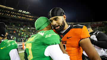 Oregon State Beavers quarterback DJ Uiagalelei hugs Oregon Ducks wide receiver Gary Bryant Jr. after