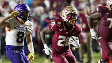 Nov 18, 2023; Tallahassee, Florida, USA; Florida State Seminoles running back Caziah Holmes (26) runs the ball in for a touchdown under pressure from North Alabama Lions linebacker Shaun Myers (8) during the third quarter at Doak S. Campbell Stadium. Mandatory Credit: Morgan Tencza-Imagn Images