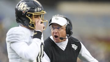 Nov 23, 2024; Morgantown, West Virginia, USA; UCF Knights head coach Gus Malzahn yells at quarterback Dylan Rizk (10) during the first quarter against the West Virginia Mountaineers at Mountaineer Field at Milan Puskar Stadium. Mandatory Credit: Ben Queen-Imagn Images