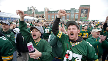 Green Bay Packers fans Hunter Evans, left, of Hartland, WI, and Rodney Wigman of Suxxex, WI, yell “Go Pack Go” during the first day of the NFL Draft presented by Bud Light at the Draft Theater Thursday, April 24, 2025, outside of Lambeau Field in Green Bay, Wisconsin.