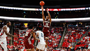 Boston College Eagles guard Donald Hand Jr. (13) shoots a three pointer past forward Chad Venning (32) and North Carolina State Wolfpack guard Jayden Taylor (8) during the second half of the game at Lenovo Center.