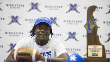 Middletown football player Tomiwa Durojaiye smiles after putting on his University of Kentucky hat during his signing ceremony Wednesday, Dec. 15, 2021.

Sports Middletown Signings