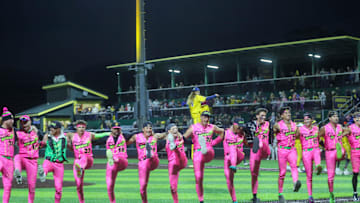 The teams perform a kick line during the Savannah Bananas first home game of the season on Friday, Feb. 21, 2025 at Historic Grayson Stadium.