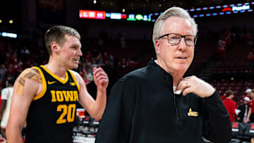Mar 9, 2025; Lincoln, Nebraska, USA; Iowa Hawkeyes head coach Fran McCaffery and forward Payton Sandfort (20) walk off the court after defeating the Nebraska Cornhuskers at Pinnacle Bank Arena. Mandatory Credit: Dylan Widger-Imagn Images
