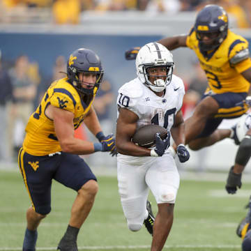 Penn State Nittany Lions running back Nicholas Singleton runs the ball during the fourth quarter against the West Virginia Mountaineers at Mountaineer Field.