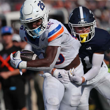 Saturday, August 31, 2024; Statesboro, Georgia; Boise State running back Sire Gaines drives for yardage as Georgia Southern's Chance Gamble attempts to bring him down during the season opener on Saturday, August 31, 2024 at Paulson Stadium in Statesboro, Georgia.