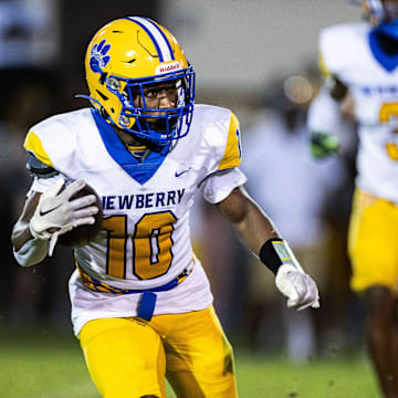 Newberry Panthers running back Jamarcus Wimberly (10) runs with the ball against the Hawthorne Hornets during the first half at Hawthorne High School Football Stadium in Hawthorne, FL on Friday, August 30, 2024. [Matt Pendleton/Gainesville Sun]