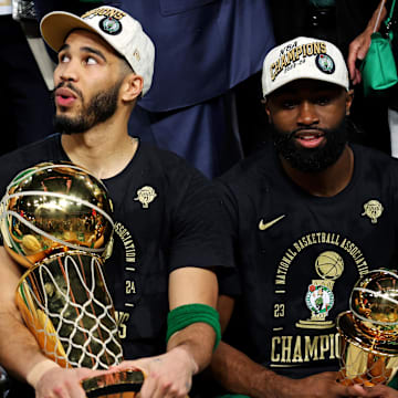 Jun 17, 2024; Boston, Massachusetts, USA; Boston Celtics forward Jayson Tatum (0) and guard Jaylen Brown (7) celebrates with the Larry O’Brien Trophy after beating the Dallas Mavericks in game five of the 2024 NBA Finals to win the NBA Championship at TD Garden. Mandatory Credit: Peter Casey-Imagn Images