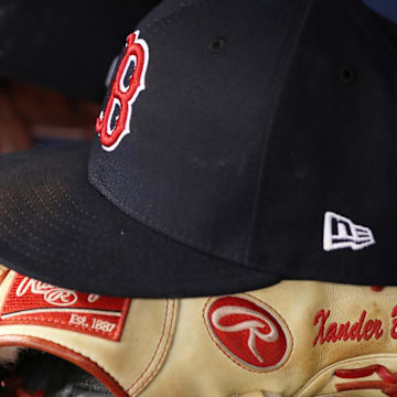 Mar 30, 2018; St. Petersburg, FL, USA; A detail view of Boston Red Sox shortstop Xander Bogaerts (2) (not pictured) baseball hat and glove in the dugout against the Tampa Bay Rays at Tropicana Field. Mandatory Credit: Kim Klement-Imagn Images
