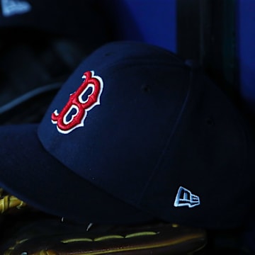Jul 22, 2019; St. Petersburg, FL, USA; A detail view of Boston Red Sox hat and glove laying in the dugout at Tropicana Field. Mandatory Credit: Kim Klement-Imagn Images
