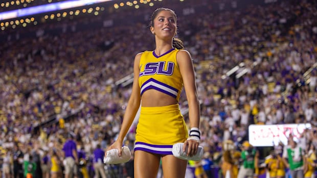 LSU Tigers cheerleader throws t-shirts to the fans during a time out in the second quarter