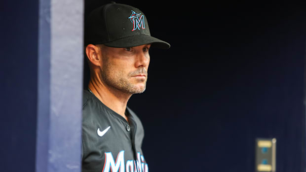 Skip Schumaker standing in the dugout before a game as manager of the Miami Marlins. 
