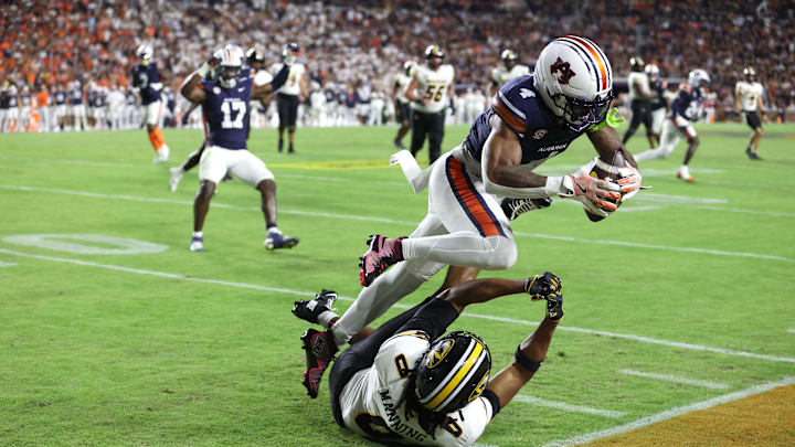 Oct 18, 2025; Auburn, Alabama, USA; Auburn Tigers cornerback Kayin Lee (4) intercepts a pass intended for Missouri Tigers wide receiver Joshua Manning (0) during the second quarter at Jordan-Hare Stadium. Mandatory Credit: John Reed-Imagn Images