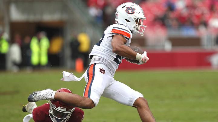 Oct 25, 2025; Fayetteville, Arkansas, USA; Auburn Tigers running back Jeremiah Cobb (23) rushes during the second quarter against the Arkansas Razorbacks at Donald W. Reynolds Razorback Stadium. Mandatory Credit: Nelson Chenault-Imagn Images