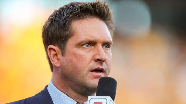 Oct 5, 2019; Morgantown, WV, USA; ESPN broadcaster Todd McShay talks along the sidelines during the fourth quarter at Mountaineer Field at Milan Puskar Stadium. Mandatory Credit: Ben Queen-Imagn Images