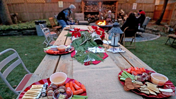 Platters of crackers, pretzel rolls, beer cheese dip, veggie sticks and cranberry chutney await guests at a backyard party in late November at the Wauwatosa home of Todd and Kelly Halverson. Firepits added some warmth and cheer to the cool-weather gathering.

Mjs Firepits13 Nws Sears 1