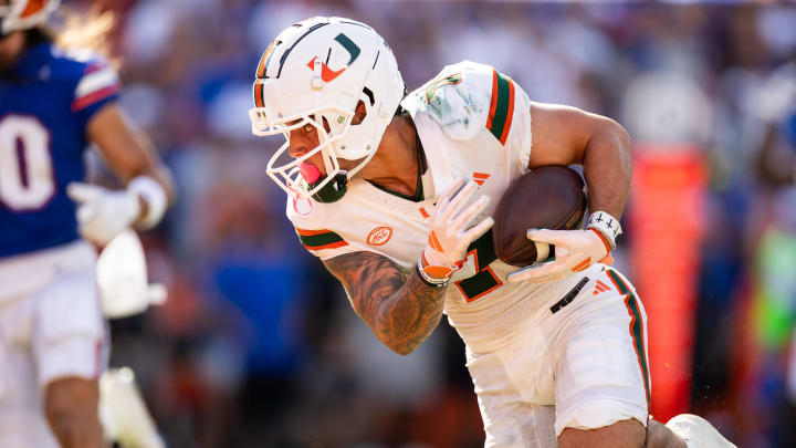 Aug 31, 2024; Gainesville, Florida, USA; Miami Hurricanes wide receiver Xavier Restrepo (7) catches a pass and runs for a touchdown against the Florida Gators during the first half at Ben Hill Griffin Stadium. Mandatory Credit: Matt Pendleton-USA TODAY Sports