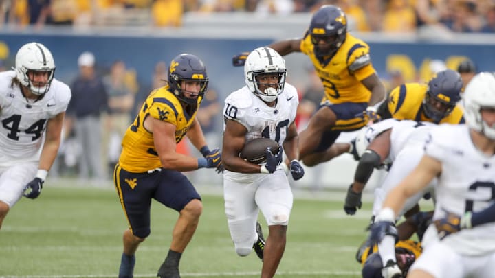 Penn State Nittany Lions running back Nicholas Singleton runs the ball during the fourth quarter against the West Virginia Mountaineers at Mountaineer Field.