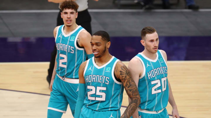 Feb 24, 2021; Phoenix, Arizona, USA; Charlotte Hornets forward P.J. Washington (25) with forward Gordon Hayward (20) and guard LaMelo Ball (2) against the Phoenix Suns at Phoenix Suns Arena. Mandatory Credit: Mark J. Rebilas-USA TODAY Sports