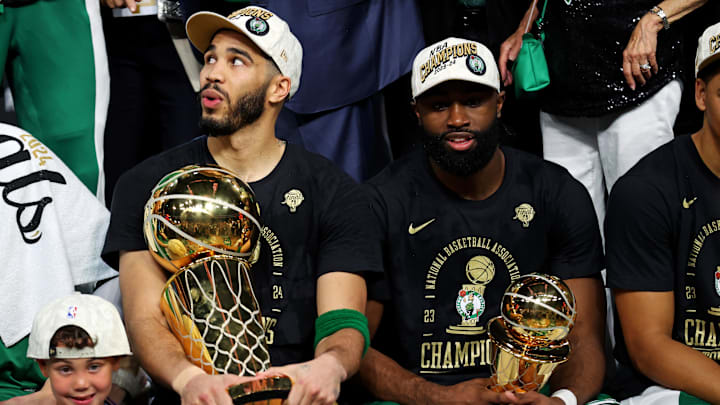 Jun 17, 2024; Boston, Massachusetts, USA; Boston Celtics forward Jayson Tatum (0) and guard Jaylen Brown (7) celebrates with the Larry O’Brien Trophy after beating the Dallas Mavericks in game five of the 2024 NBA Finals to win the NBA Championship at TD Garden. Mandatory Credit: Peter Casey-Imagn Images