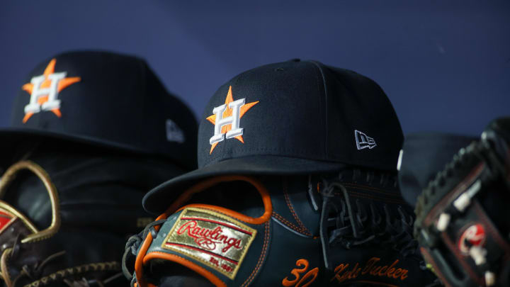 Apr 21, 2023; Atlanta, Georgia, USA; A detailed view of a Houston Astros hat and glove in the dugout against the Atlanta Braves in the fifth inning at Truist Park. Mandatory Credit: Brett Davis-USA TODAY Sports