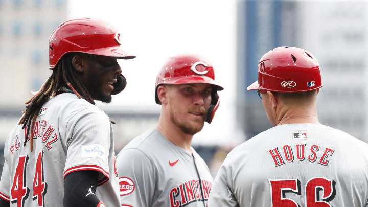 Aug 25, 2024; Pittsburgh, Pennsylvania, USA;  Cincinnati Reds shortstop Elly De La Cruz (44) and catcher Tyler Stephenson (middle) and third base coach J.R. House (56) talk at third base during a Pittsburgh Pirates pitching change in the seventh inning at PNC Park. Mandatory Credit: Charles LeClaire-USA TODAY Sports