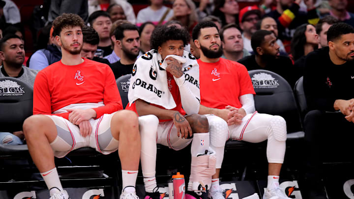 Dec 27, 2023; Houston, Texas, USA; (from L-to-R) Houston Rockets center Alperen Sengun (28), Houston Rockets guard Jalen Green (4) and Houston Rockets guard Fred VanVleet (5) sit on the bench during the fourth quarter against the Phoenix Suns at Toyota Center. Mandatory Credit: Erik Williams-Imagn Images